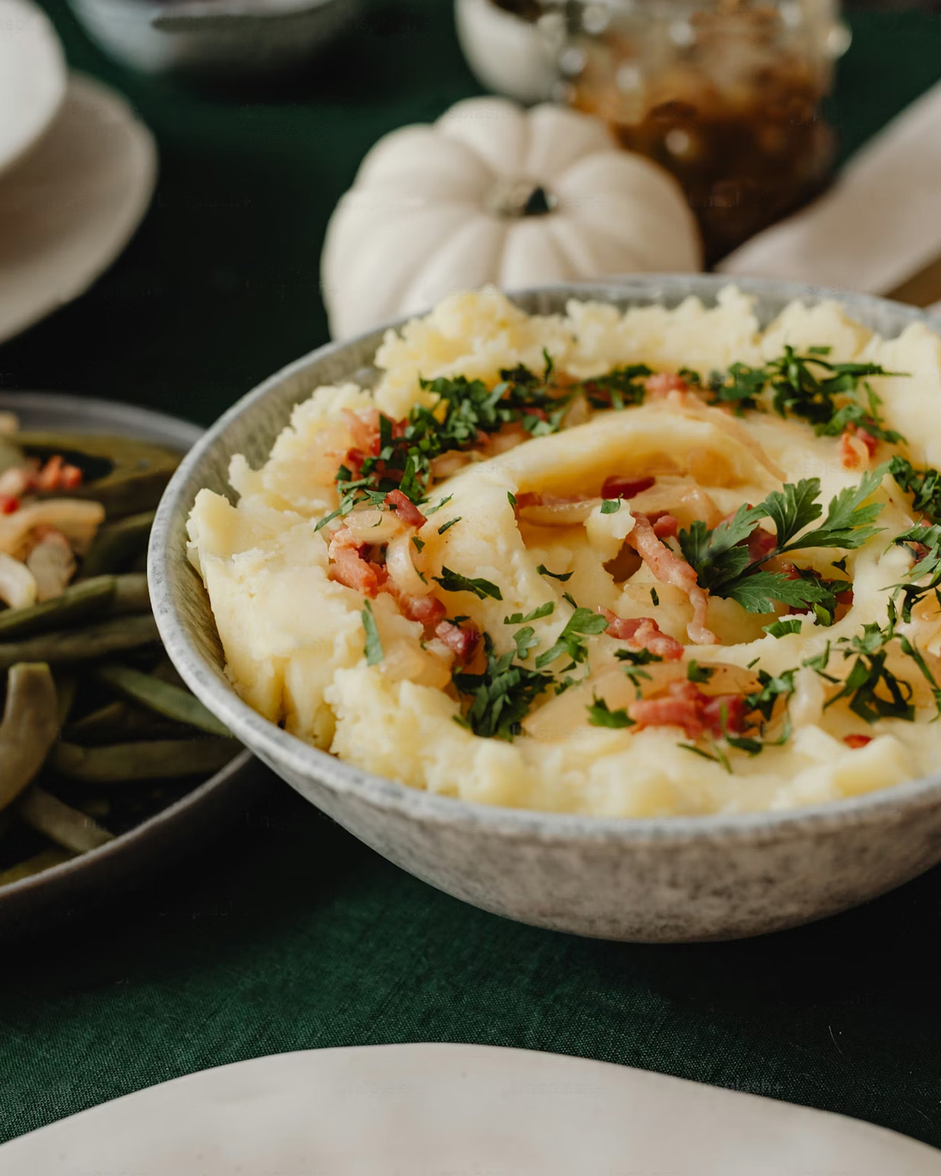 Une purée de pommes de terre dans un bol assaisonnée de lardons
